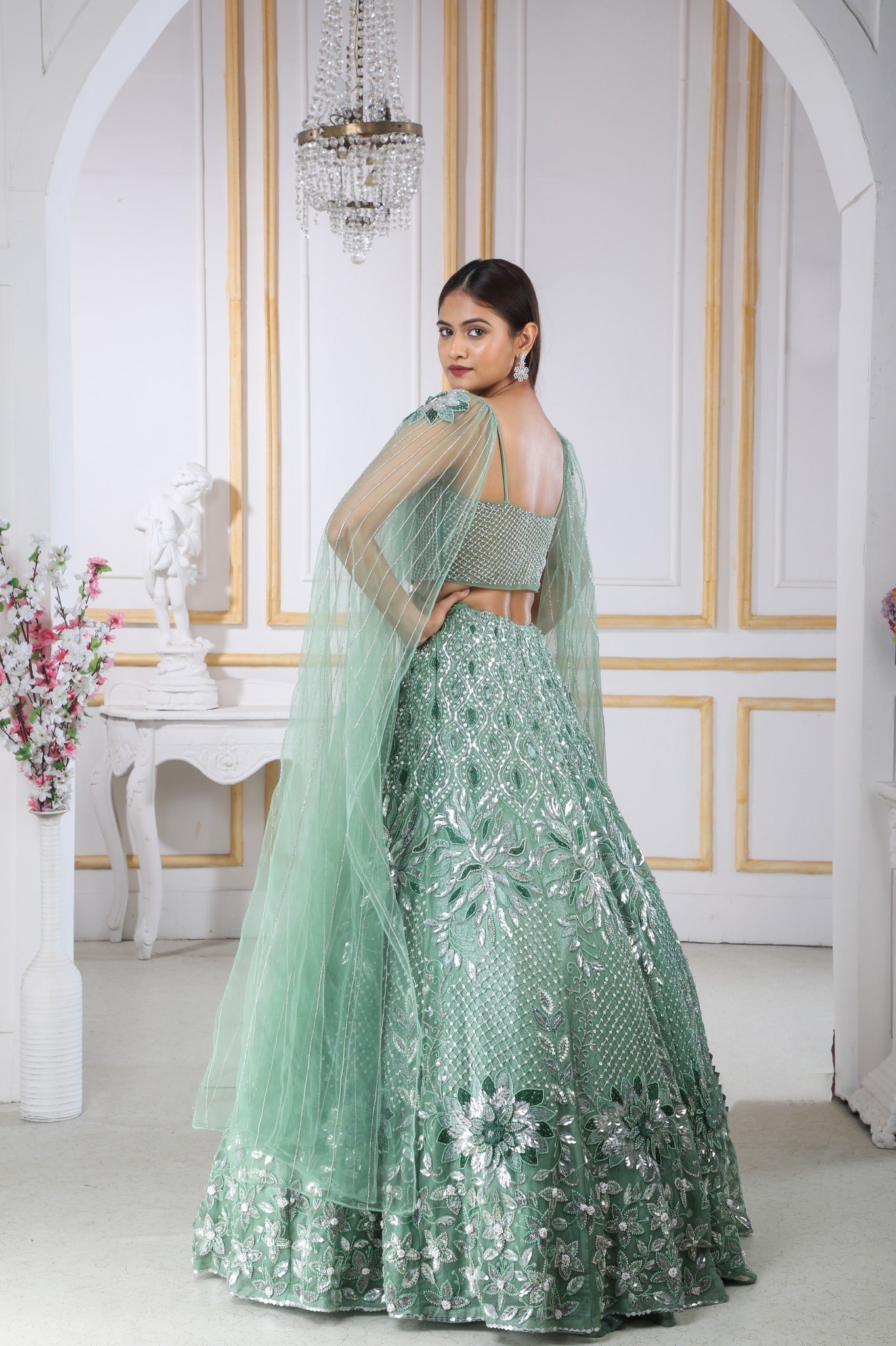 Green Heavy Lehenga With A Crop Top In Long Cape Embroidered Sleeves