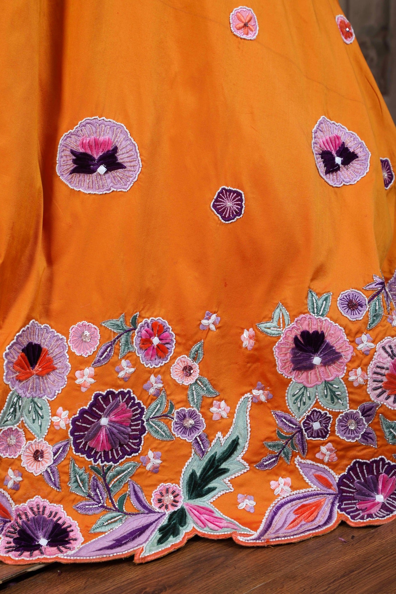 Burnt Orange Lehenga & Purple Choli With Resham Embroidered Summer Blossoms Along The Hemline And Scattered Buttis