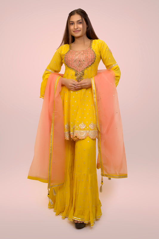 Mustard Yellow Sharara Suit In Chinnon With A Flared Kurti Adorned In Handwork On Yoke