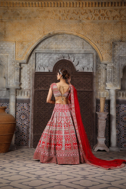 Red bridal embellished with Zari, zardozi,  katdana, and more