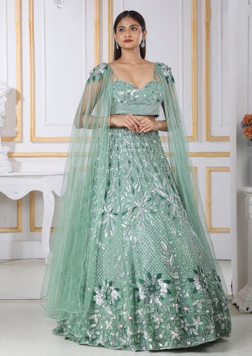 Green Heavy Lehenga With A Crop Top In Long Cape Embroidered Sleeves